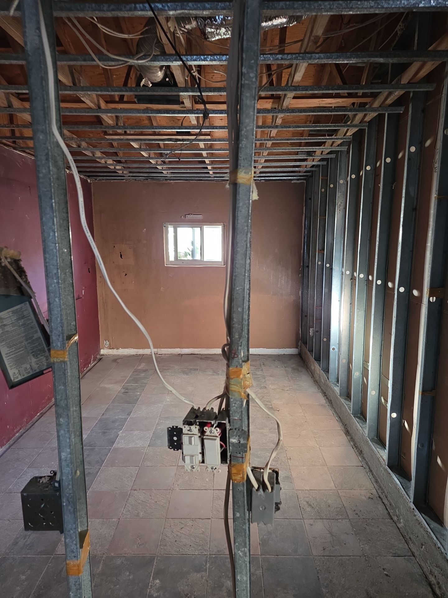 Room gutted to bare studs and open ceiling after fire damage restoration